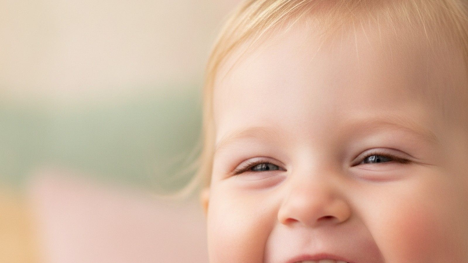 A giggling toddler with deep cheek dimples